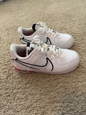 Nike White Low-Top Sneakers with Black Swoosh and Red Accents